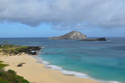 hawaiian coast with cloudy sky and beach