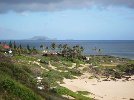 hawaiian coast with cloudy sky and beach