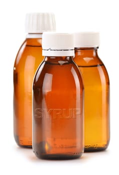 Bottles of syrup medication on white background