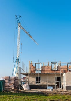 construction site with scaffolding and a crane