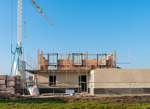 construction site with scaffolding and a crane