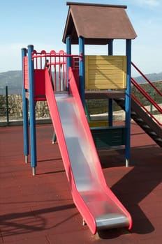 Red metal slider at a childrens playground