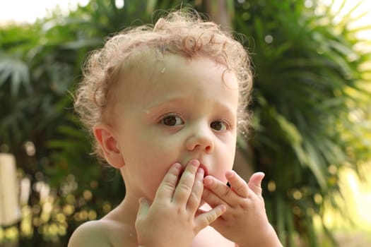 little boy eating food with their hands