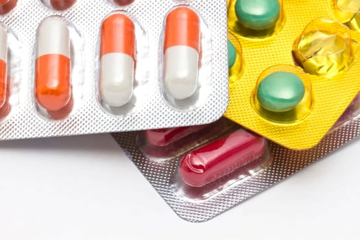 Colorful pills closeup on white background