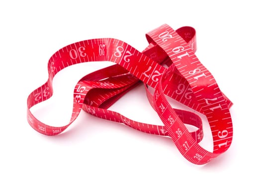 Red tape measure closeup on white background