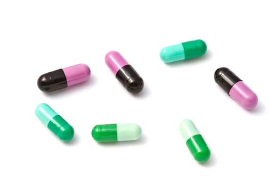Colorful capsules closeup on white background