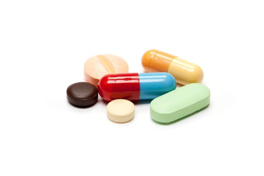 Tablets,different pills in different colors against white background