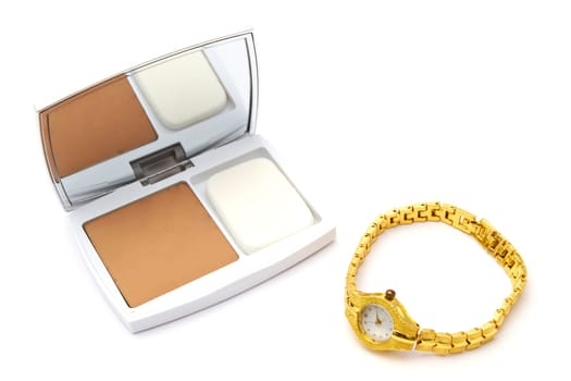 Powder compact and watch closeup on white background