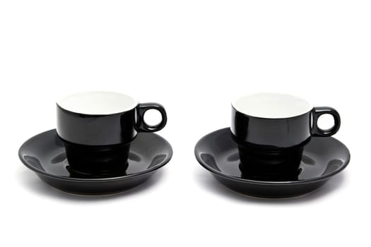Black coffee cups closeup on white background