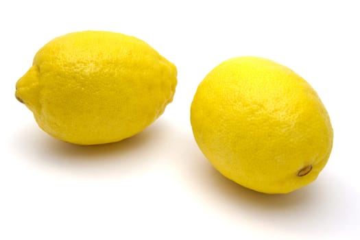 Two fresh lemons closeup on white background