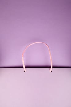 Paper bag with handles on pink cardboard
