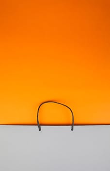 Paper bag with handles on orange cardboard
