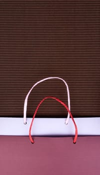 Paper bag with handles on brown corrugated cardboard