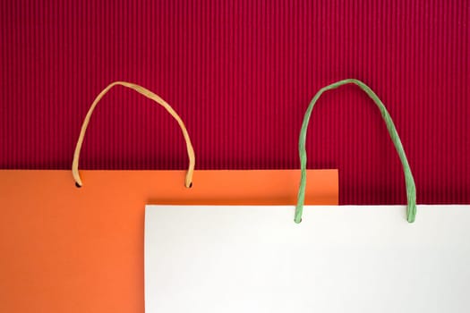 Paper bag with handles on red background
