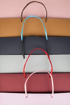 Paper bags with handles on pink cardboard