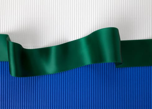 Green ribbon banner on corrugated cardboard