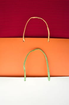 Paper bag with handles on red background