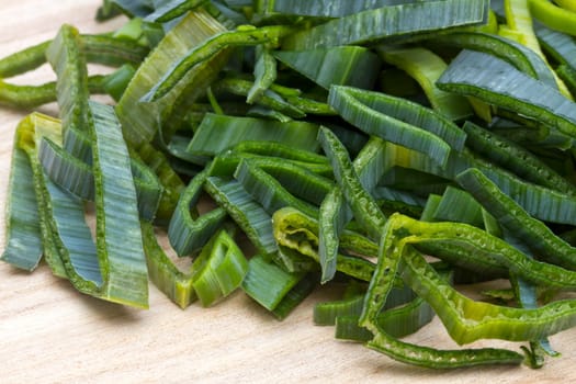 fresh cut leek closeup onwood background