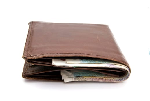 Wallet and currency closeup on white background