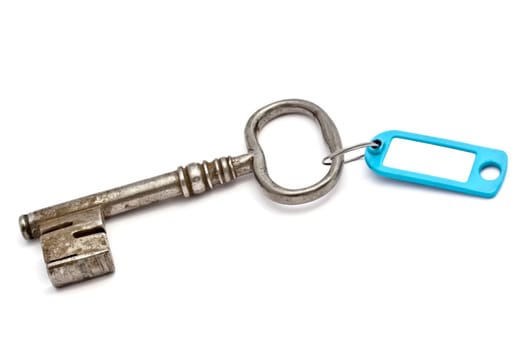 Key with a success tag closeup on white background