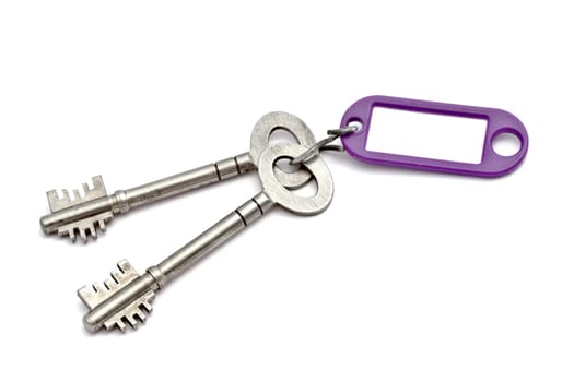 Key with a success tag closeup on white background