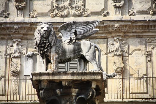 The Lion of St. Mark - here a symbol of Venice's rule - on a column in Piazza delle Erbe in Verona in front of Palazzo Maffei,Italy