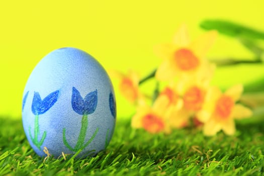Easter decoration made of single,colorfully painted,Easter egg in green artificial grass
