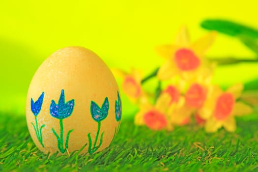 Easter decoration made of single,colorfully painted,Easter egg in green artificial grass