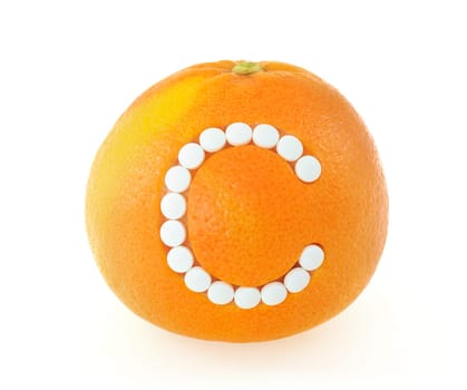 Grapefruit with vitamin c pills over white background - concept