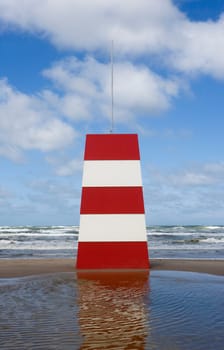 Red and White Landmark on the beach