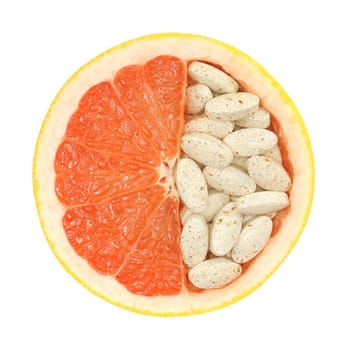 Close up of red grapefruit and pills isolated - vitamin concept