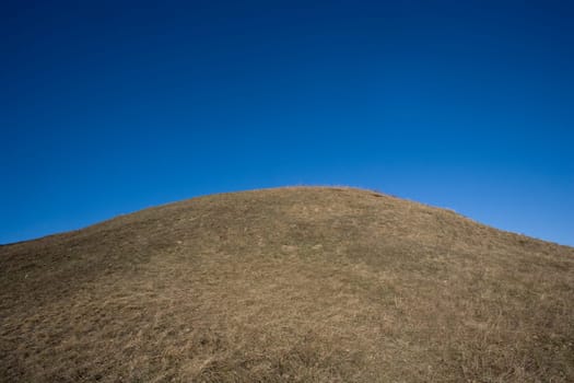 Hill towards dark blue sky