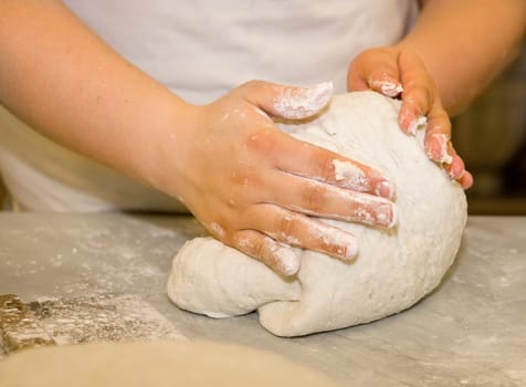 Close up of a woman kneading dough