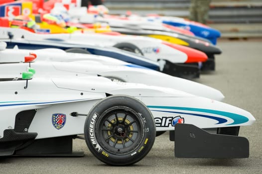 Line of race cars in the Park Firme paddock during the Formula Renault Championships, at Thruxton, UK - May 1, 2011