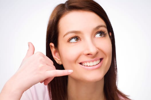 Young woman making call sign close up