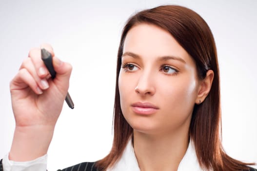 Young business woman writing on glass close up
