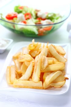 Baked potatoes with dip and vegetable salad with tunny