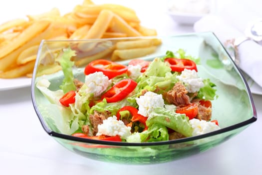 Mixed vegetable salad with tuna, cottage cheese and baked potatoes in background