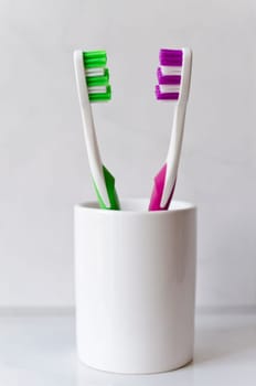 Two colored toothbrushes isolated