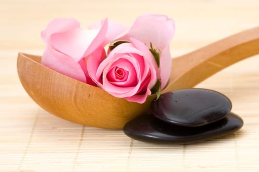 spa stones and pink rose