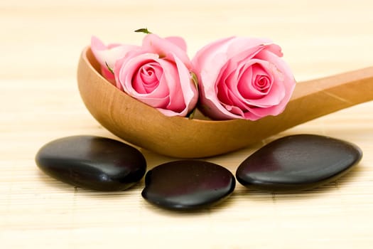 spa stones and pink roses