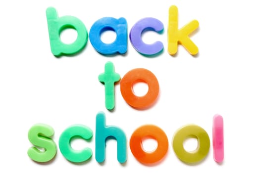 Sentence Back to school in colorful plastic letters over white