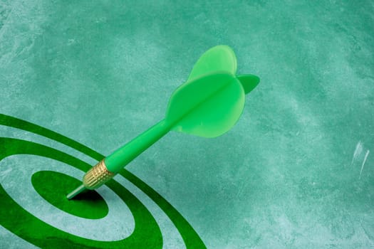success conceptual. green dart hitting the target center.