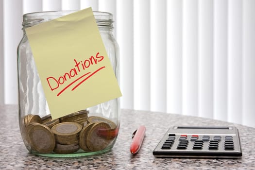 Help for others . jar for donations,pen and calculator.