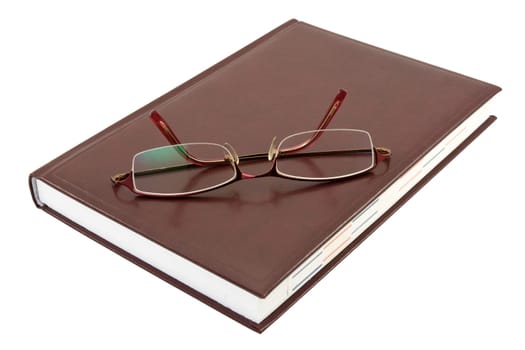 eyeglasses and book isolated on white background