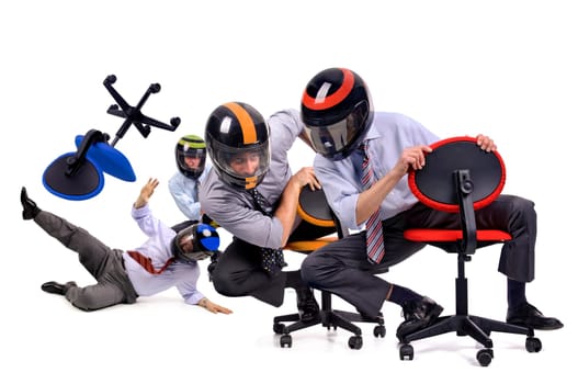 Businessmen racing in chairs with helmets