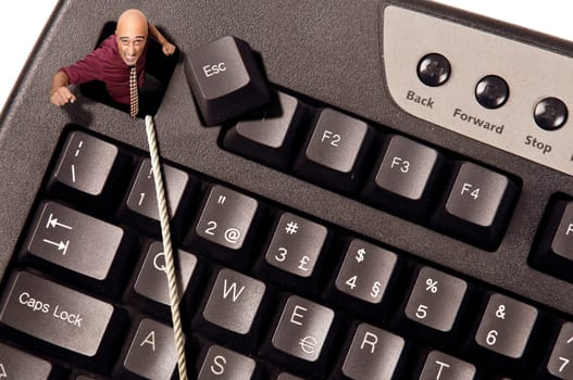 Businessman escaping from Escape key in a computer keyboard