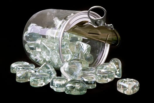 Jar with crystal heart-shaped on black background