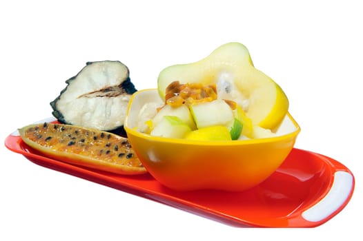 salad with tropical fruits on white background