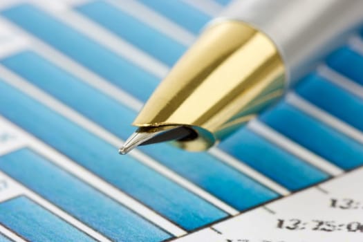 close up of pen on financial  graphs. very shallow dof